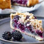 Veganer Streuselkuchen mit Brombeeren und Mohn! Jeder der Streusel liebt sollte diese gesunde Version eines klassischen Streuselkuchens mit einem Vollkornmürbeteig aus Dinkel und Nussmus, einer süchtigmachenden Mohn-Grießfüllung, erfrischend süßen Brombeeren und bedeckt mit zimtigen Nussstteusel probieren. vegan | milchfrei | eifrei | ölfrei | raffiniert zuckerfrei | sojafrei | vegetarisch #veganerstreusel #streuselkuchen #brombeeren #mohn #milchfrei