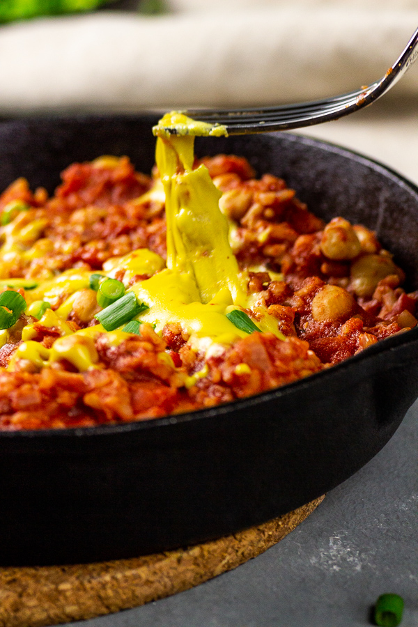 vegan enchilada skillet with rice and vegan cheese sauce