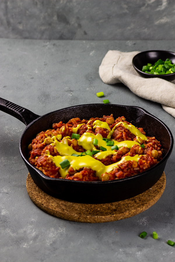 vegan enchilada skillet with rice and vegan cheese sauce