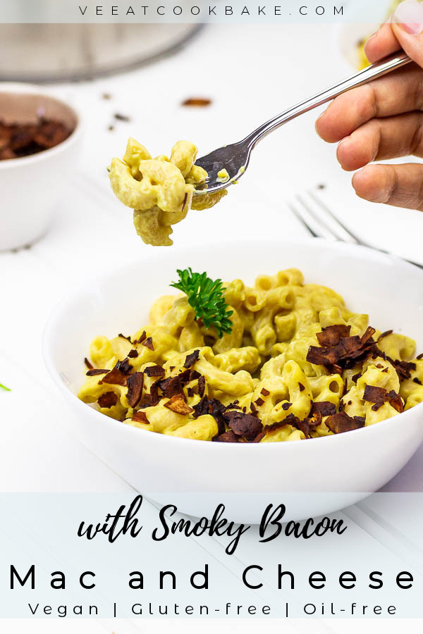 Holding a fork with vegan mac and cheese above a wfpb macaroni and cheese bowl.