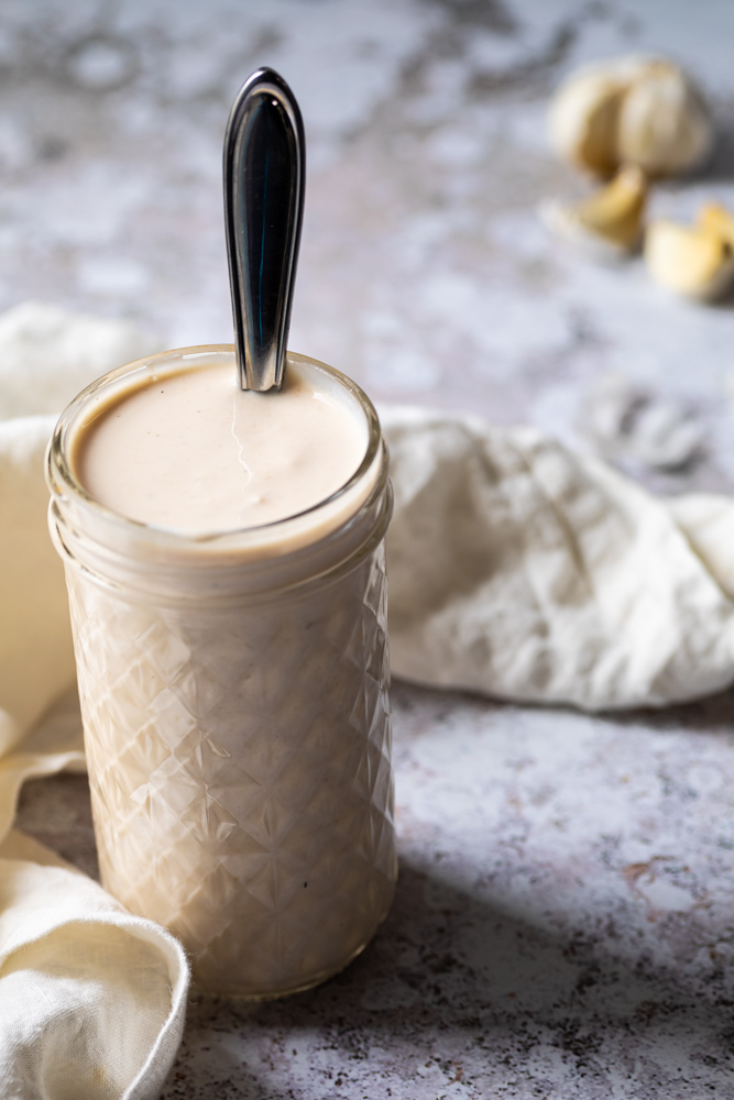 jar filled with vegan garlic sauce