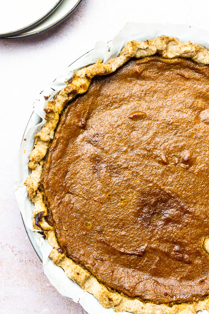 Vegan Pumpkin Pie Slice on a Plate with Whipped Coconut Cream for a Thanksgiving Dessert