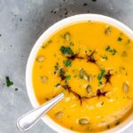 Vegan Roasted Pumpkin Soup which is creamy and made without oil. Topped with pumpkin seed, balsamic and herbs