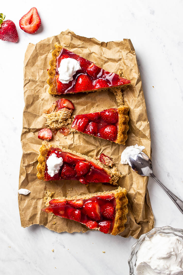 Slices of vegan strawberry jello cake on parchment paper