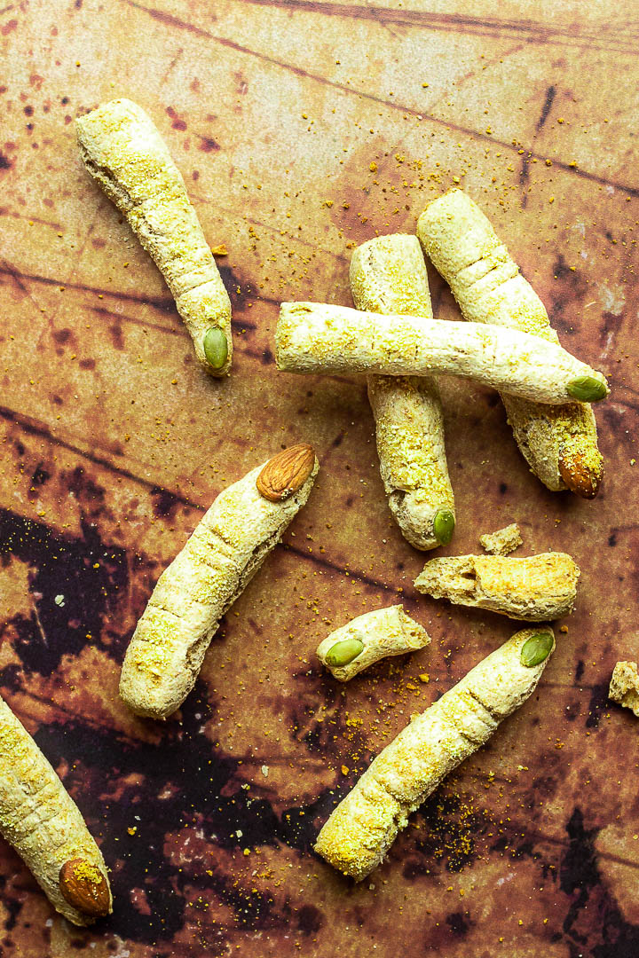 Halloween Bread Sticks in shape of witch fingers with vegan parmesan cheese and Almond / Pumpkin Seed Fingernails. Crunchy Fluffy Bread Sticks made of whole spelt / wheat pizza dough