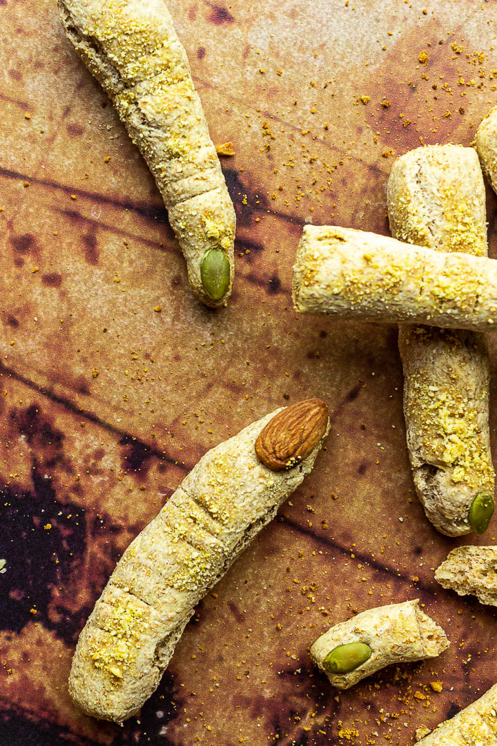 Halloween Bread Sticks in shape of witch fingers with vegan parmesan cheese and Almond / Pumpkin Seed Fingernails. Crunchy Fluffy Bread Sticks made of whole spelt / wheat pizza dough