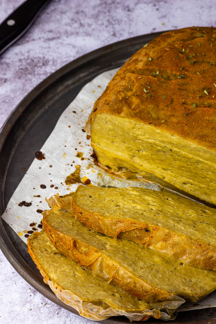 Vegan Turkey Roast Seitan on a Plate made with Chickpeas, Tahini and a flavorful seasoning blend.