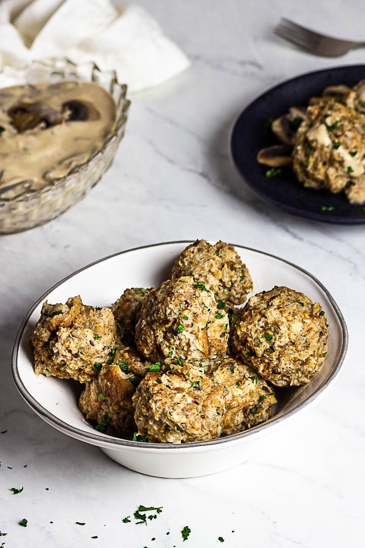 Vegan Semmelknödel are German Bread Dumplings. Presentation in a bowl with some mushroom stroganoff