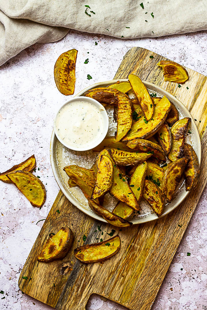 Homemade oven baked whole food plant-based potato wedges. These vegan french fries are made without oil and super quick baked.