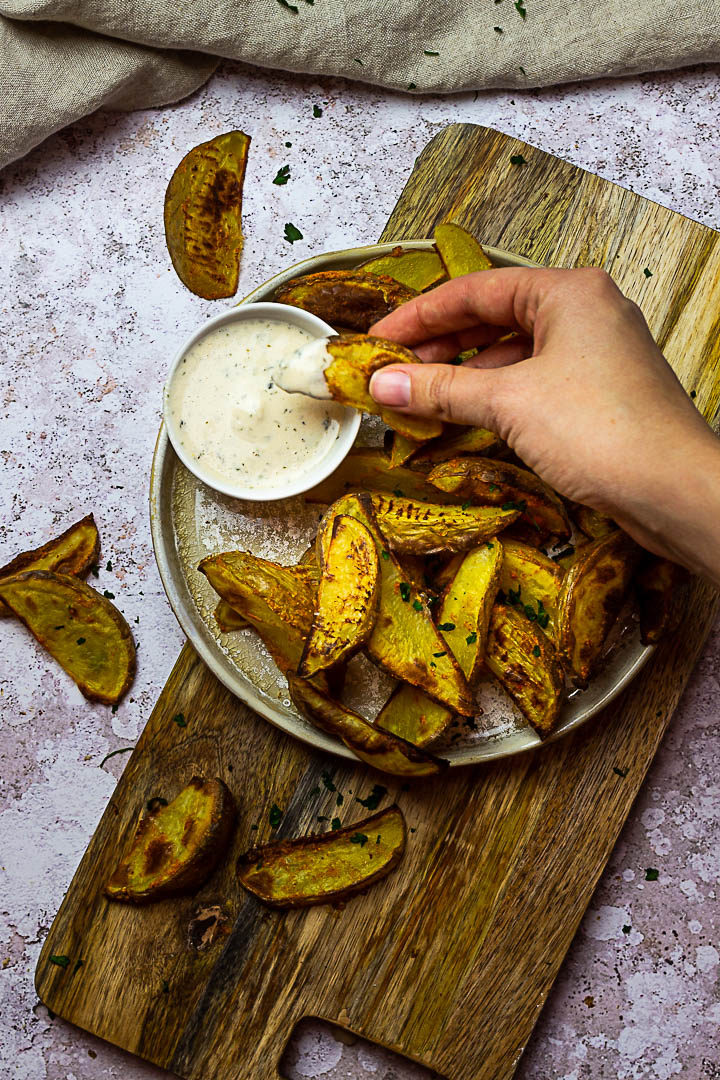 Homemade oven baked whole food plant-based potato wedges. These vegan french fries are made without oil and super quick baked.