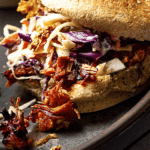 Vegan Pulled Pork made with Jackfruit, BBQ Sauce topped with Coleslaw and homemade oil-free french fried onions
