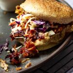 Vegan Pulled Pork zubereitet mit Jackfrucht, BBQ Soße und getoppt mit amerikanischem Coleslaw und selbstgemachten ölfreien Röstzwiebeln