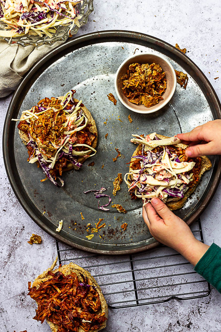 Vegan Pulled Pork made with Jackfruit, BBQ Sauce topped with Coleslaw and homemade oil-free french fried onions