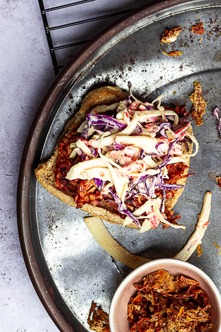 Vegan Pulled Pork made with Jackfruit, BBQ Sauce topped with Coleslaw and homemade oil-free french fried onions