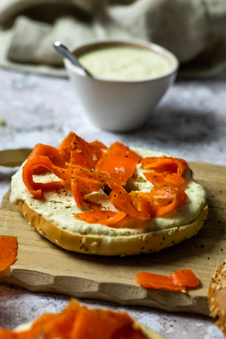 Vegan smoked salmon made with carrots. Wfpb carrot lox on a bagel with homemade oil-free horseradish dip