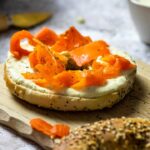 Vegan smoked salmon made with carrots. Wfpb carrot lox on a bagel with homemade oil-free horseradish dip