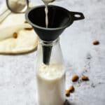 Pouring some almond milk in a jar