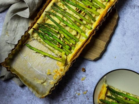 Vegan Asparagus Tart with Puff Pastry and a Creamy Cheese with two plates with pieces of the asparagus tart.