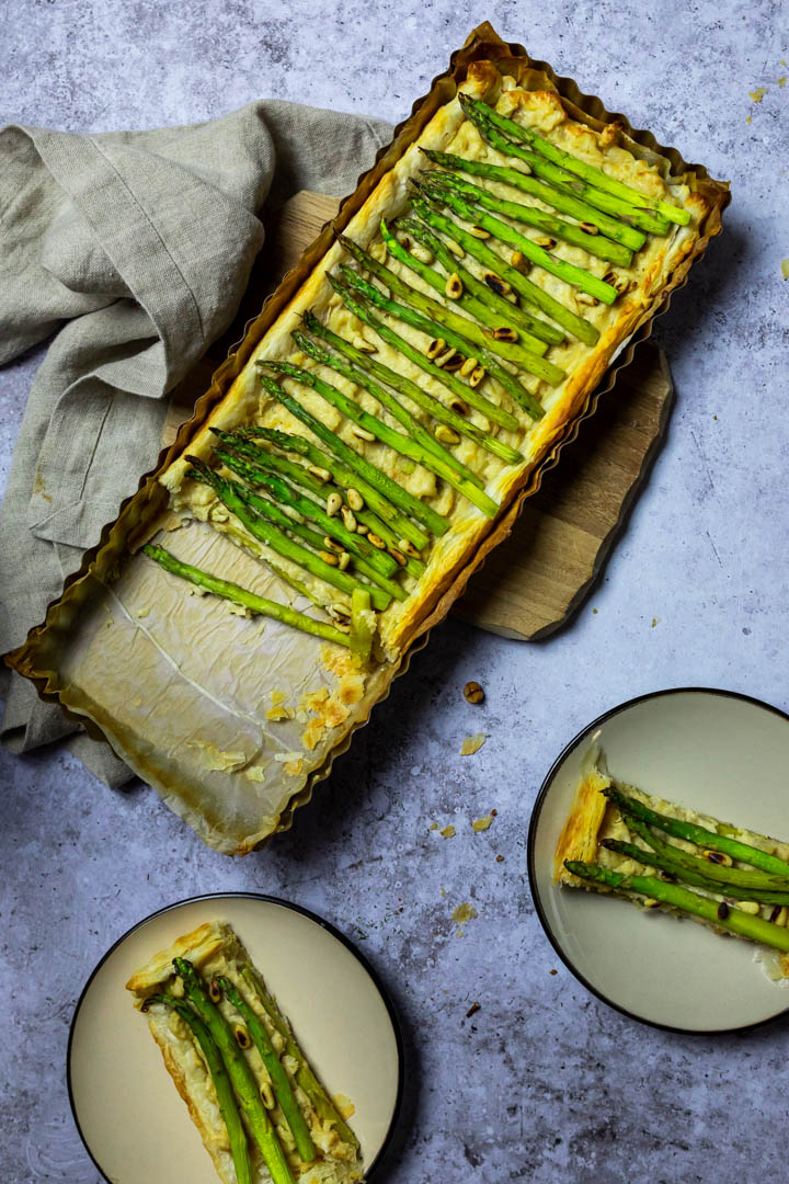 Vegan Asparagus Tart with Puff Pastry and a Creamy Cheese with two plates with pieces of the asparagus tart.