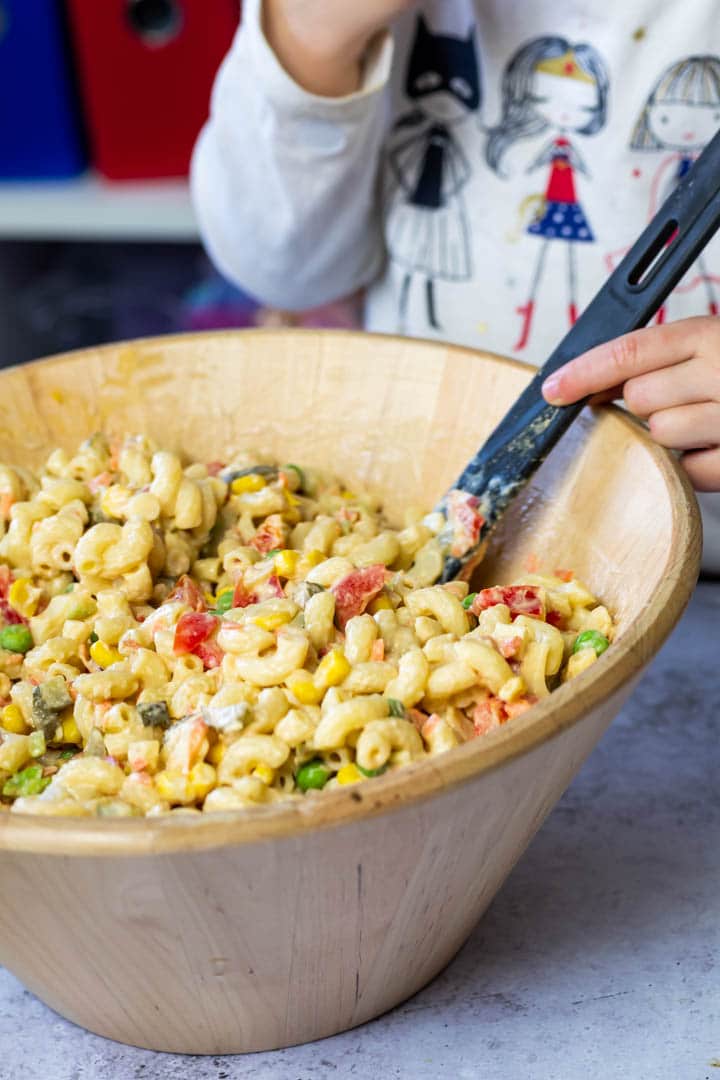 Bowl of the macaroni pasta salad. In the background my daughter holding the serving spoon.