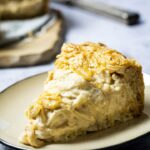 A piece of a vegan onion tart with wfpb ingredients on a plate