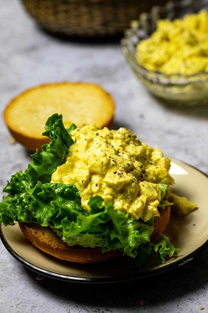 Close up of vegan egg salad on a bun