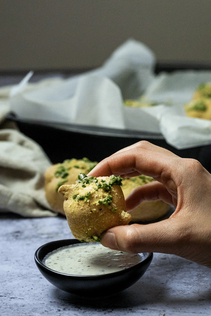 Holding one Vegan Garlic Knot