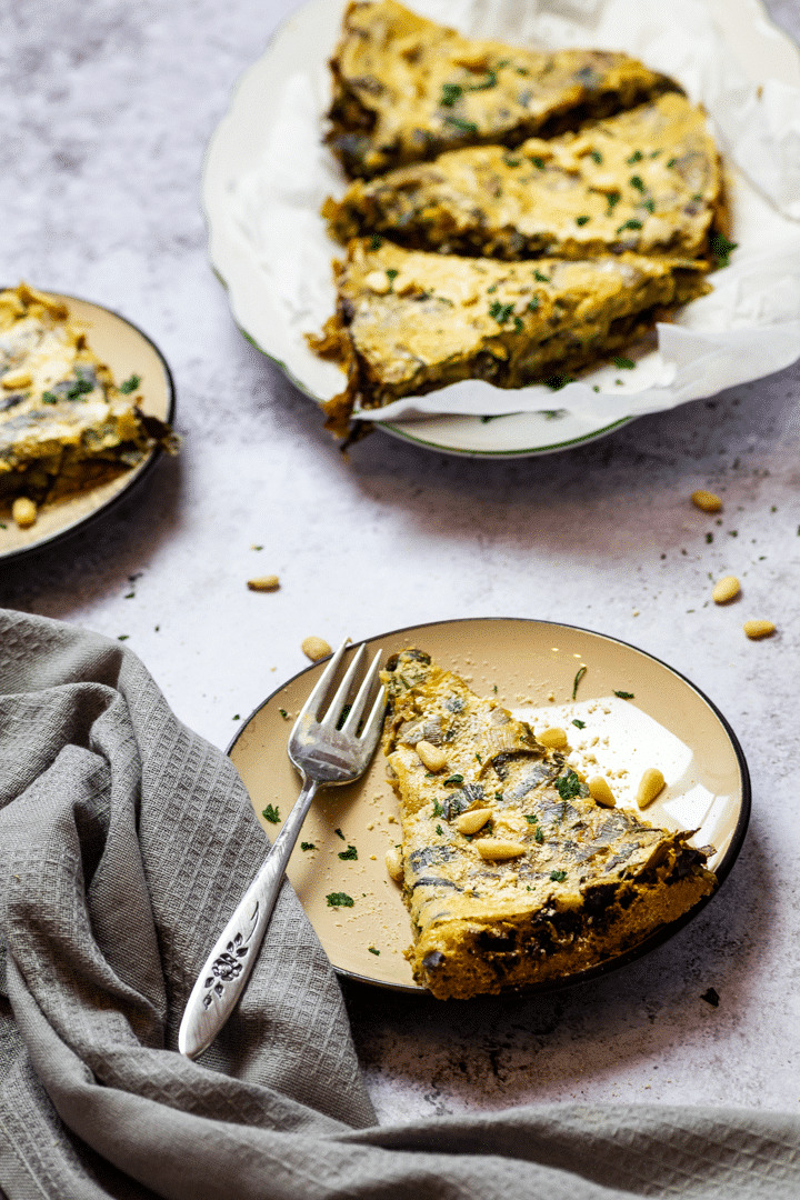 Vegan leek quiche with a platter and two plates