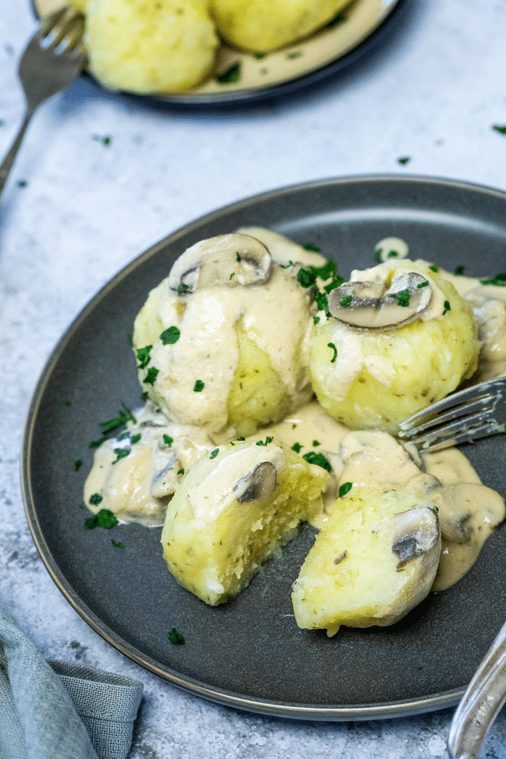 Halved vegan potato dumpling with mushroom sauce