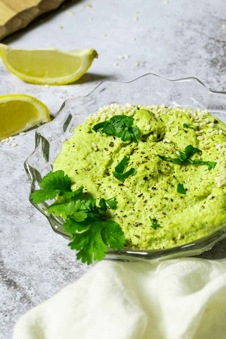 A glass bowl with oil-free edamame hummus