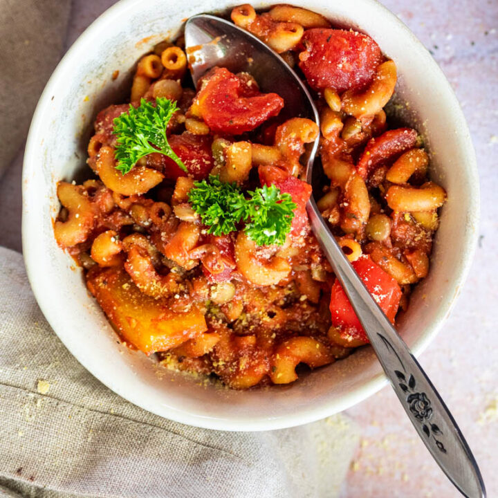 Flatlay of vegan american goulash in a bowl with a spoon