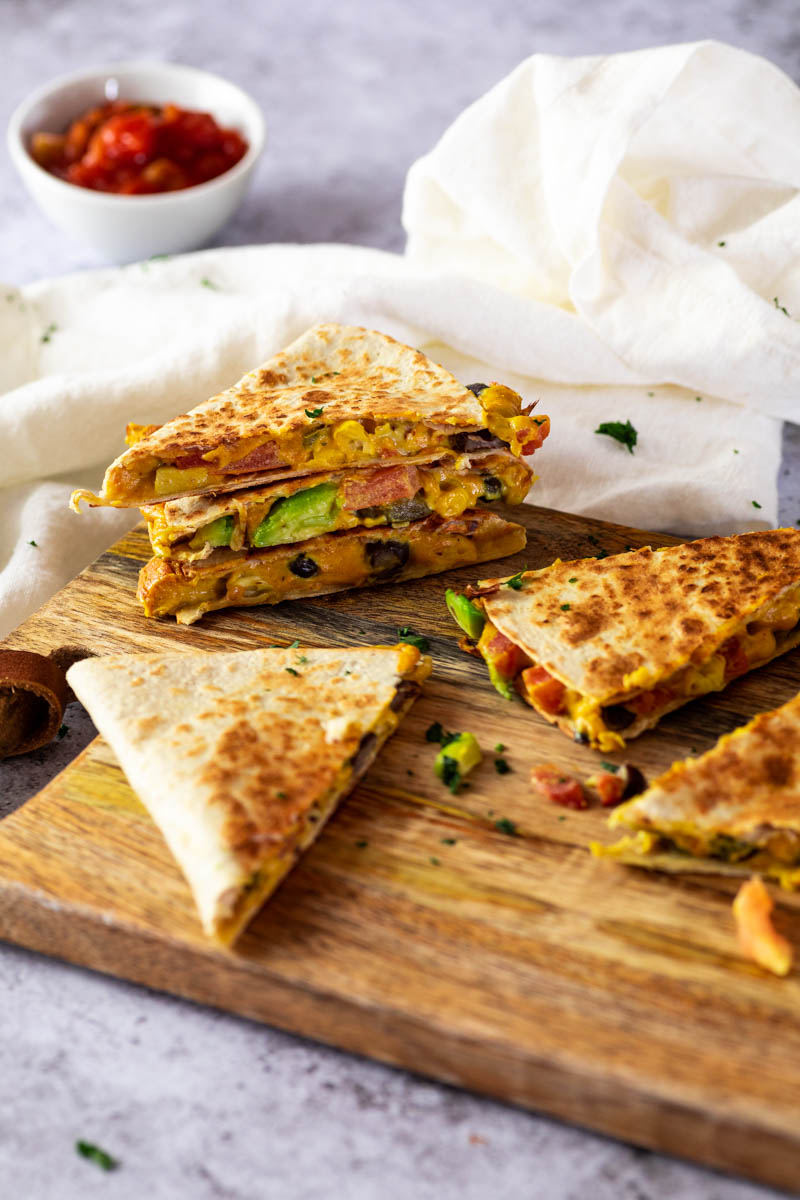 Plant-based vegan Quesadillas filled with veggies and a homemade plant-based quesco sauce