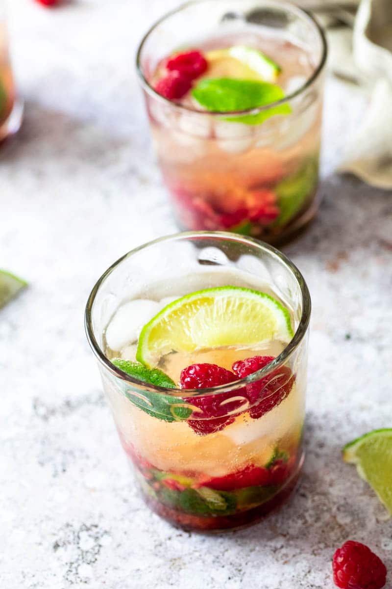 two glasses with raspberry mojitos