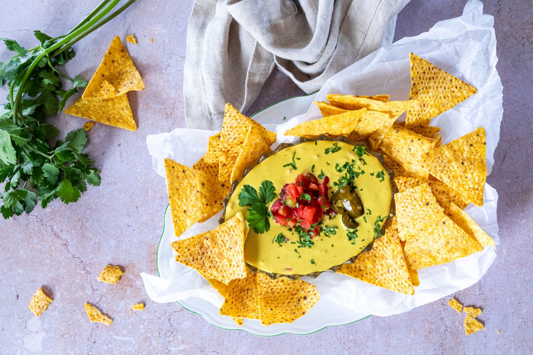 Bird View of queso dip served in a bowl with tortilla chips