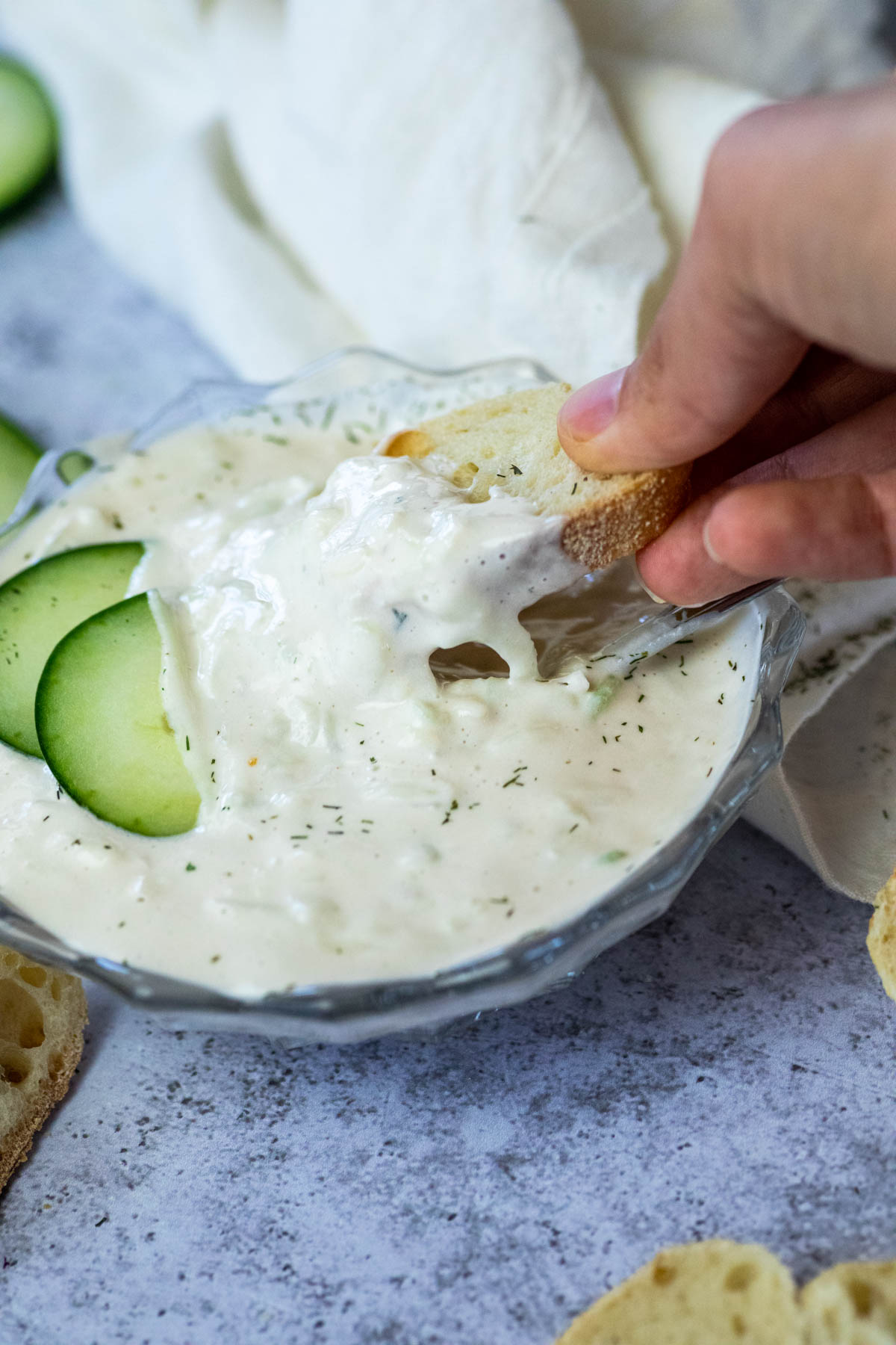 Dipping a bread in vegan tatziki