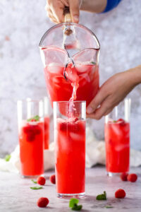 Pouring some sugar-free raspberry limeade in glasses