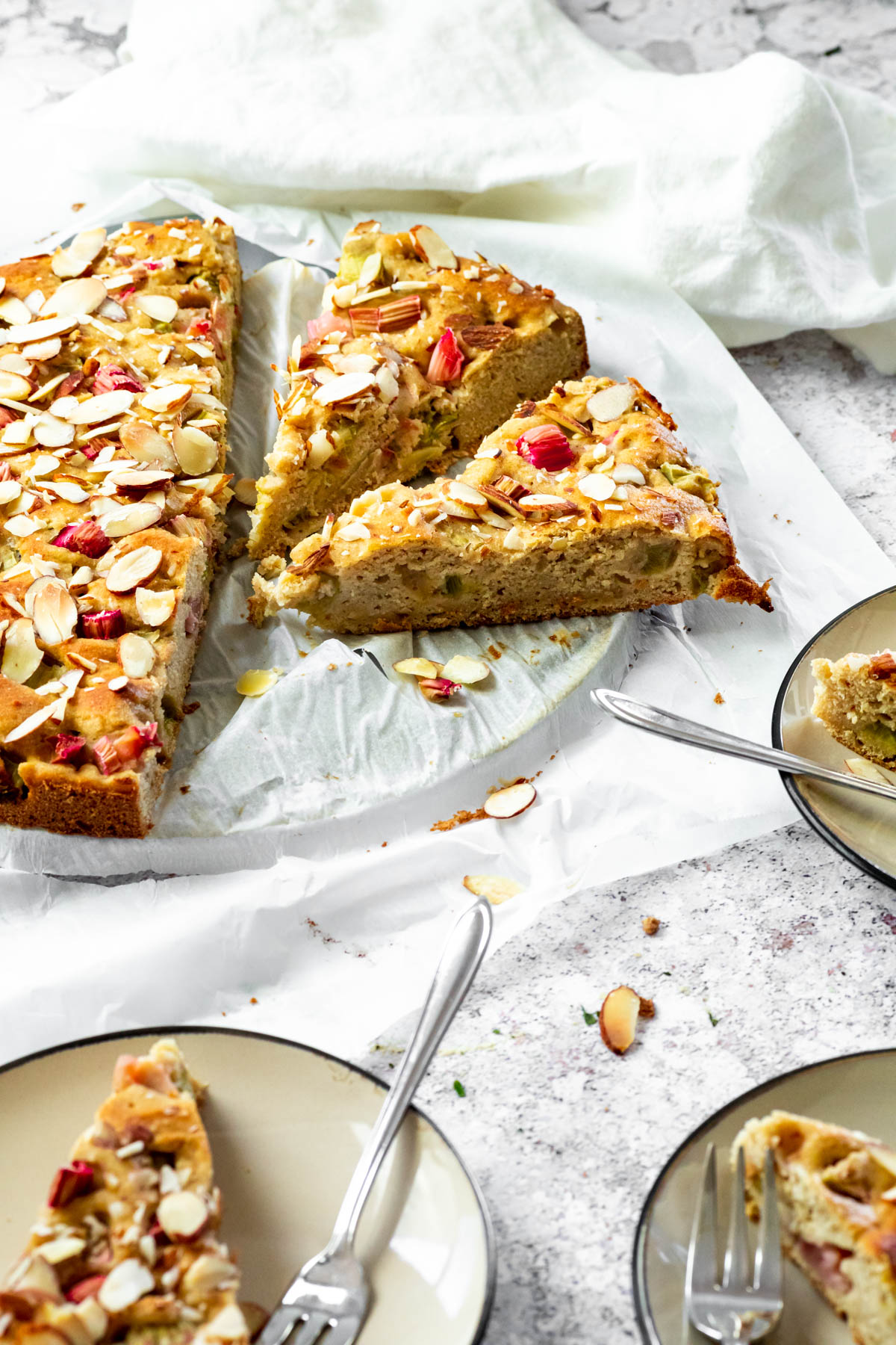 Vegan Rhubarb cake with a sliced piece in focus