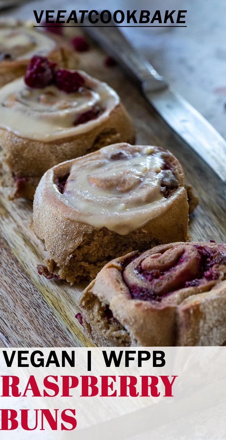 4 vegan raspberry cinnamon buns on a wood board with a knive in the background and text.