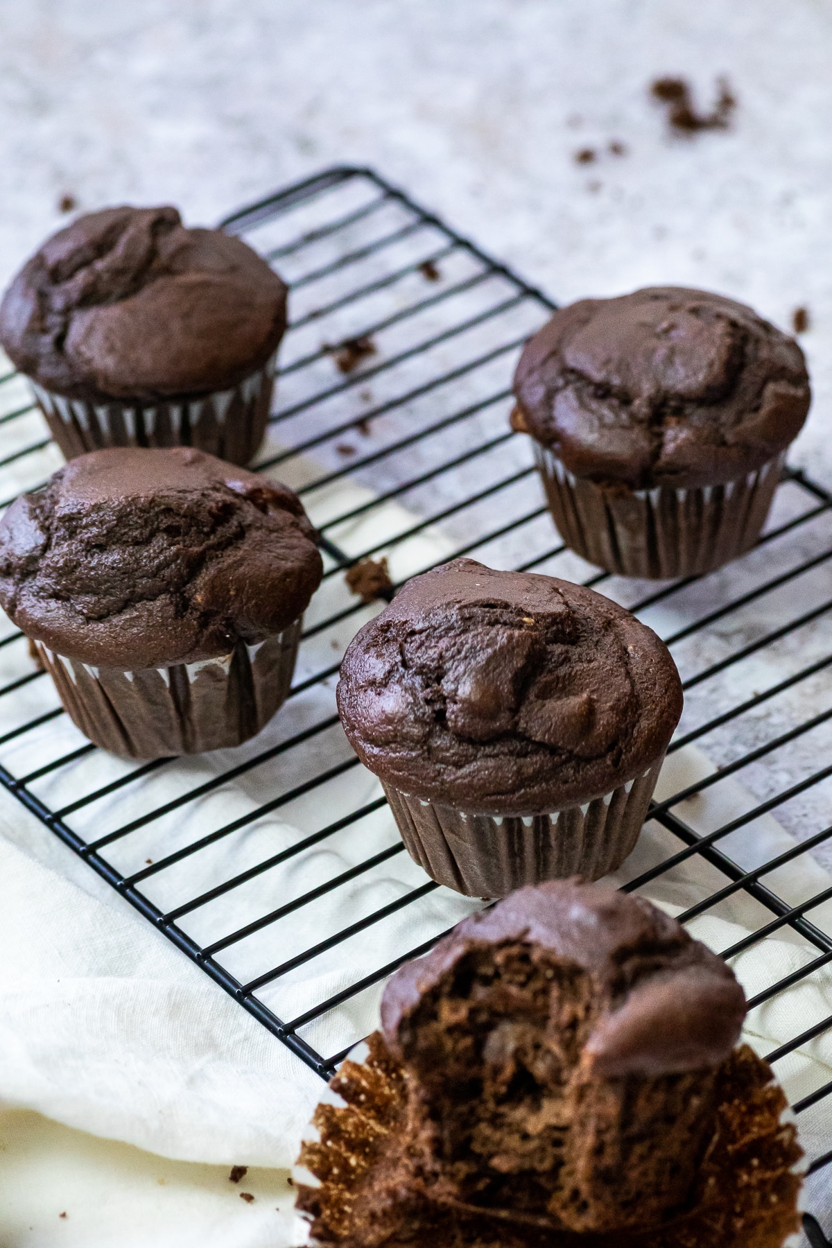 4 Chocolate Muffins on a wire rack.