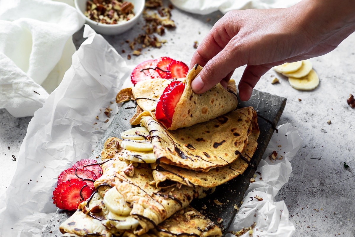 Grapping one crepe from the plate