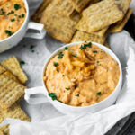 Onion Dip topped with french fried onions with crackers around.