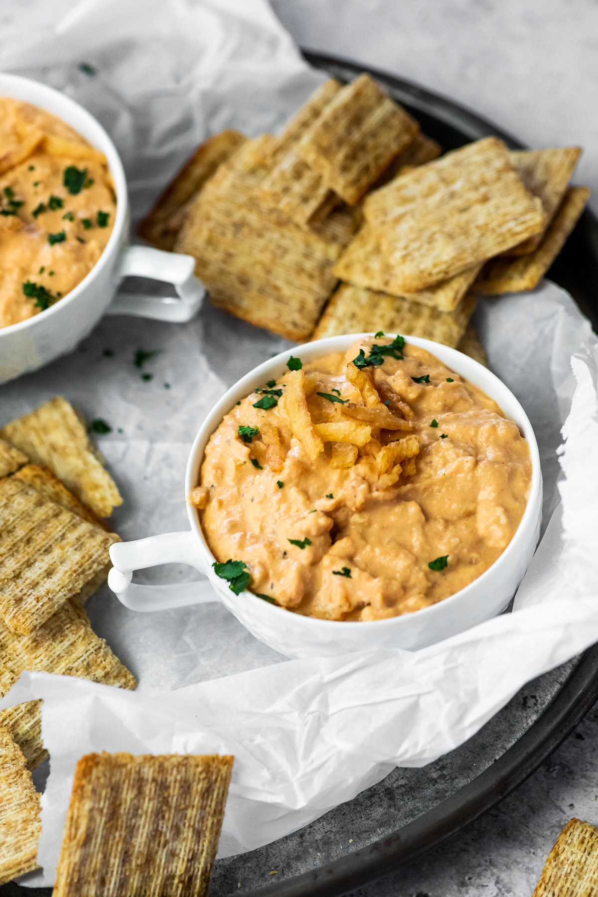 Onion Dip topped with french fried onions with crackers around.