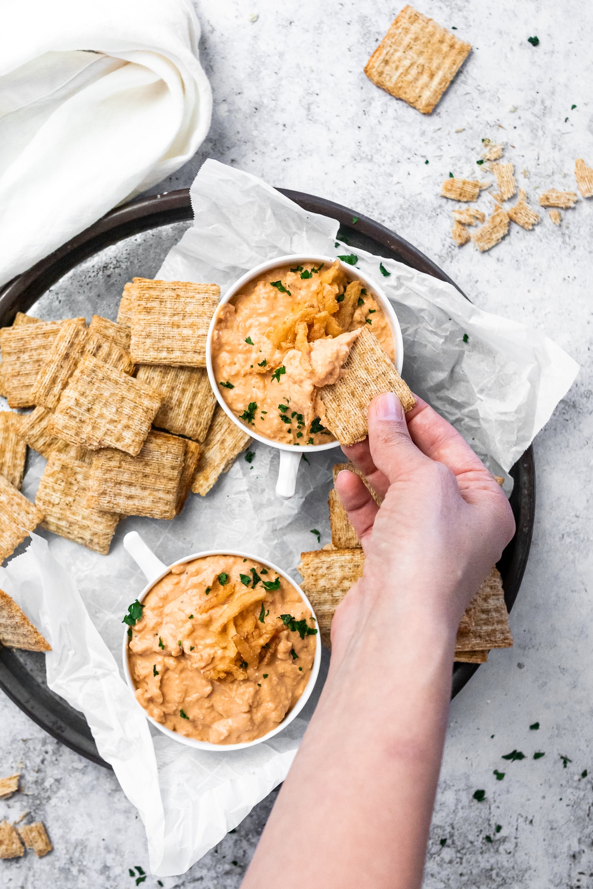 Dipping a cracker in some vegan onion dip