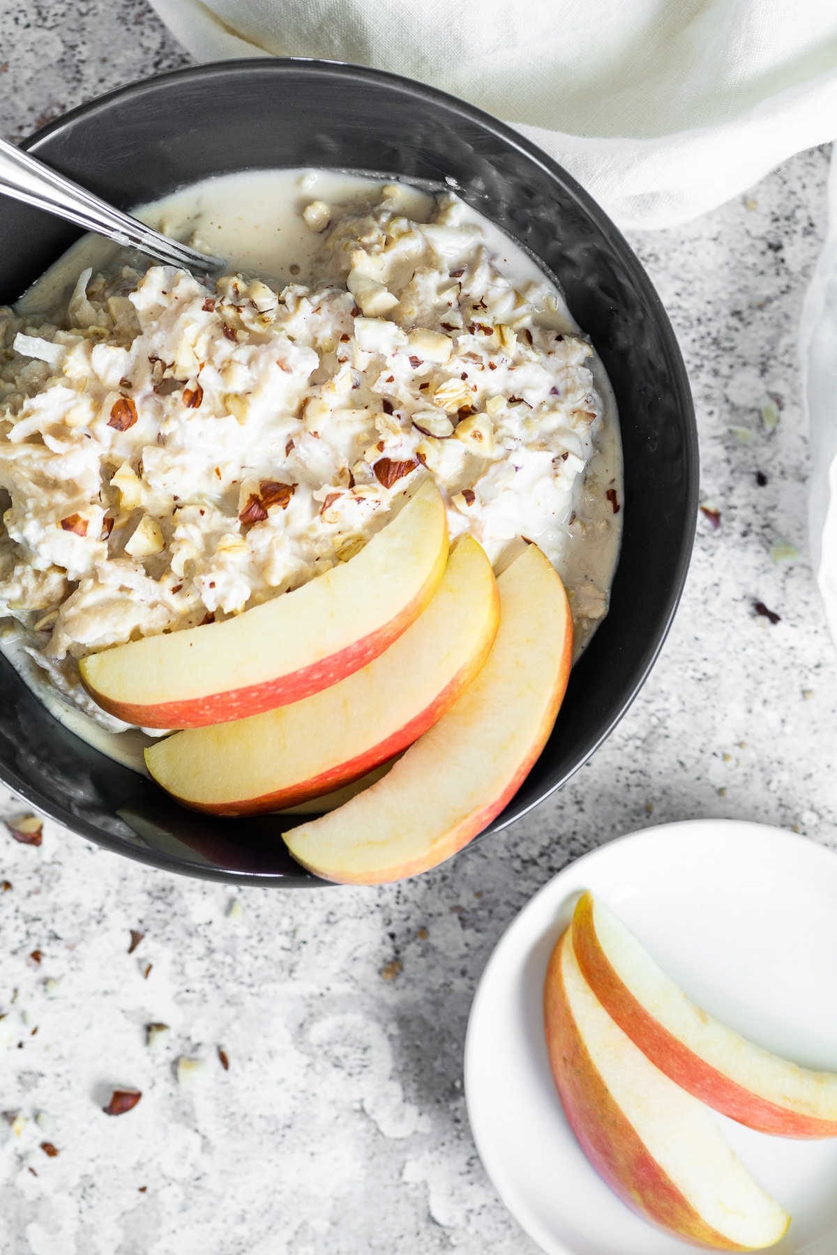 Bird View of the vegan bircher muesli served in a black bowl.