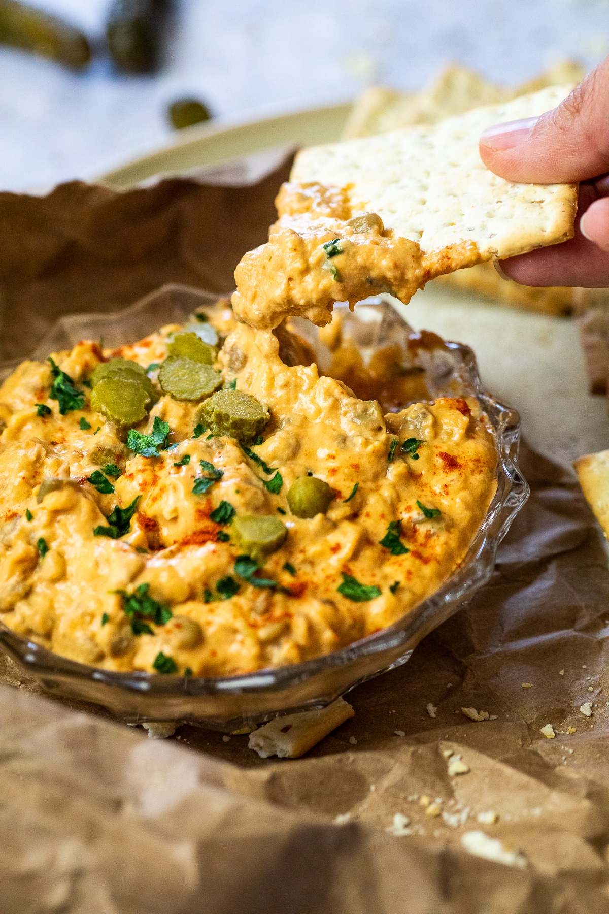 Close up of the dipped cracker with cheeseburger dip