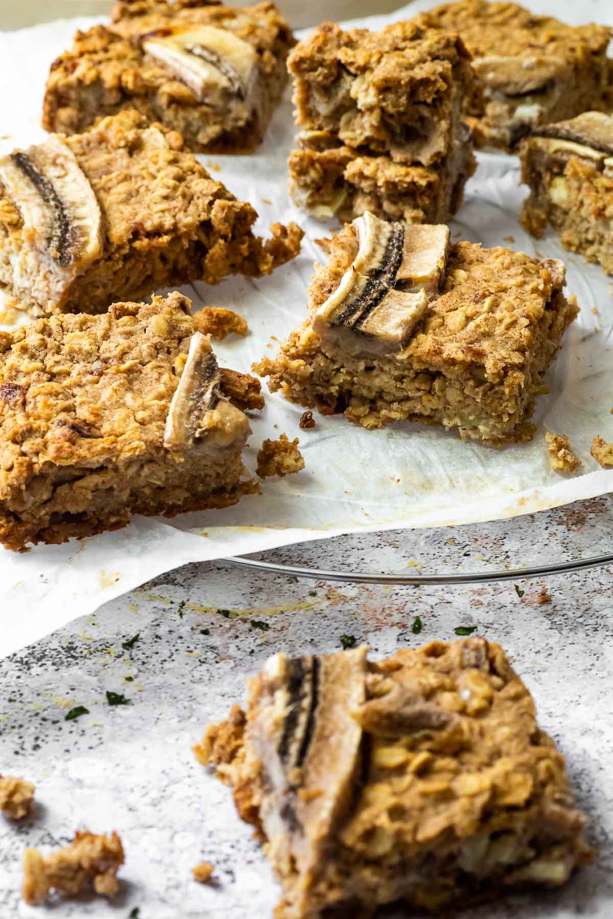 7 Oat Bars on a wire rack with one oat bar in front blurred.