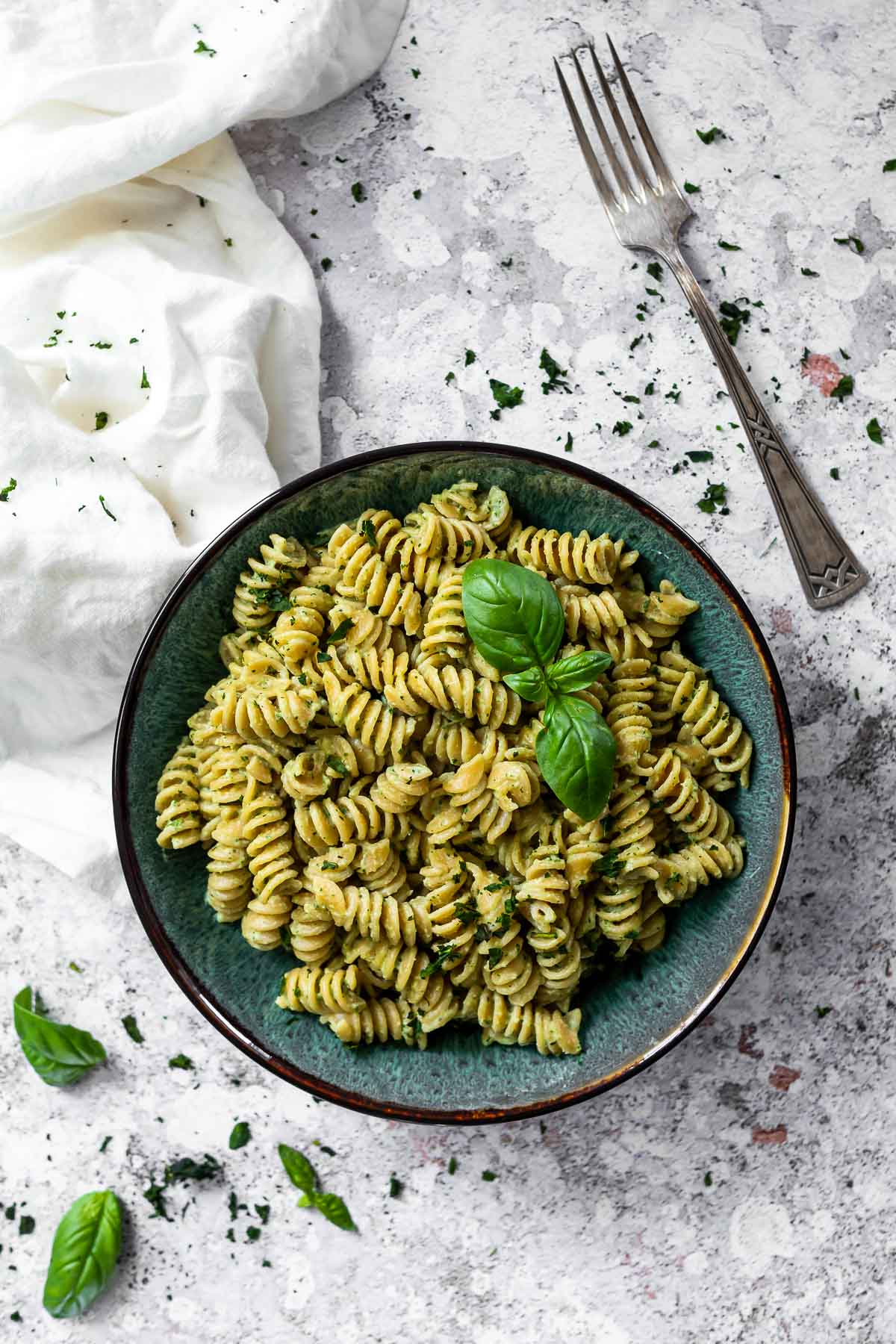 Bowl with vegan pasta dressed in a vegan basil cream sauce.