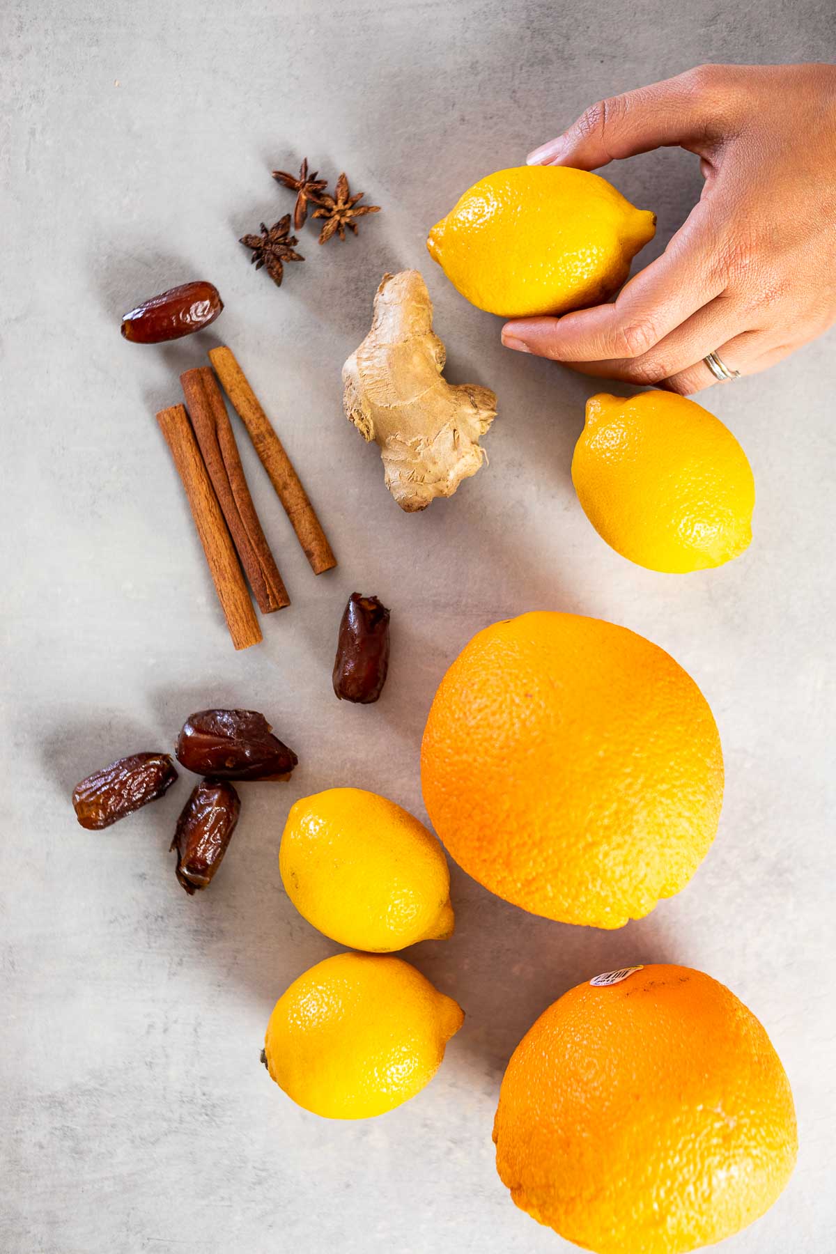 Ingredients shot of the winter lemonade: Anise, cinnamon sticks, dates, lemon, oranges, ginger