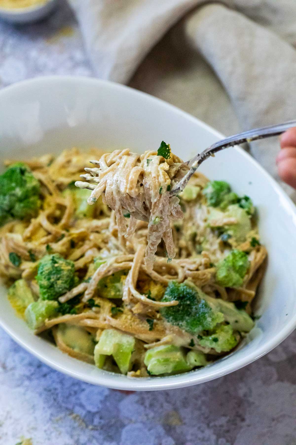 A fork full with creamy vegan Alfredo Spaghetti