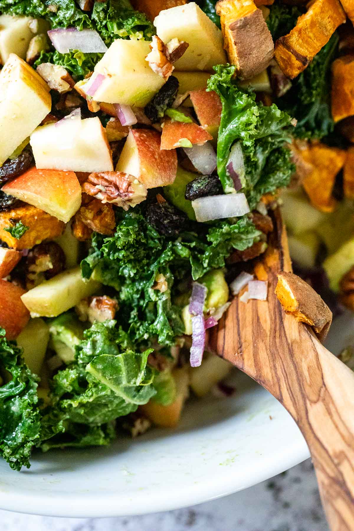 Close up of vegan kale salad with apples with sweet potato